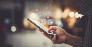 Mobile phone scrolling and some react icons on image.(Digital marketing for small businesses)