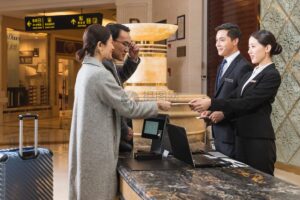 Two receptionist Dealing With Their Two Costumer